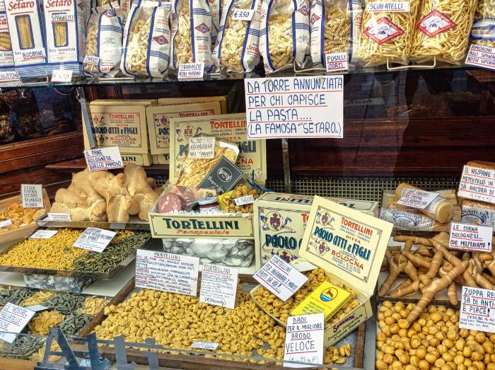 ancient market area, bustling with fresh produce and gourmet delights, offers an authentic taste of Bologna