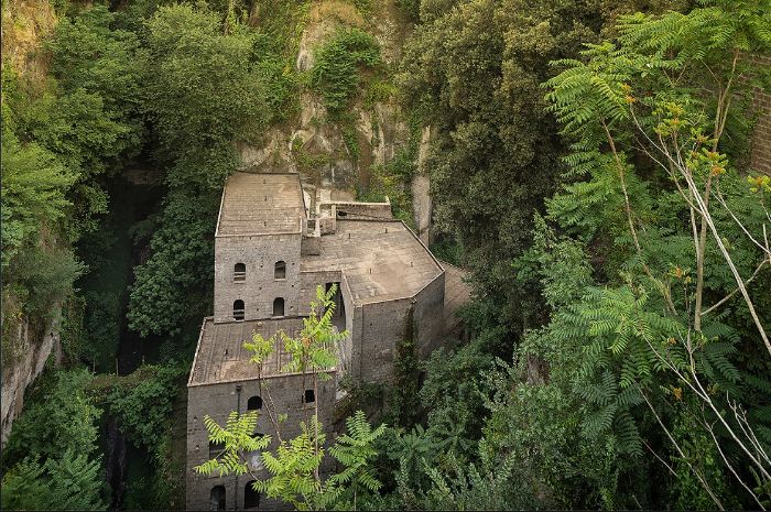 Old mill buildings surrounded by vegetation in Sorrento’s Vallone dei Mulini