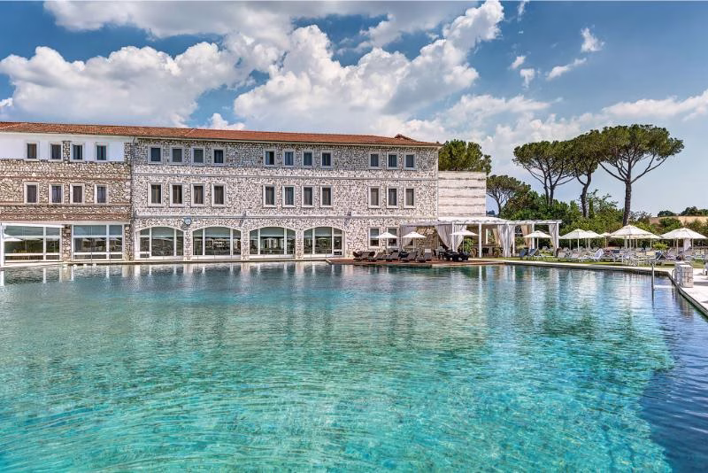 Terme di Saturnia Resort with its thermal spring pool and stone façade in the Tuscan Maremma countryside