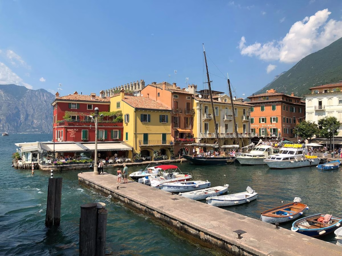 Colourful buildings and moored boats around Malcesine harbour on Lake Garda