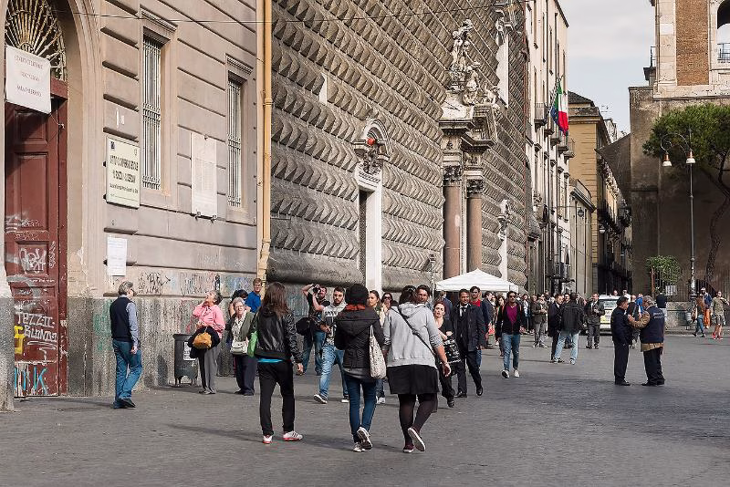 Piazza del Gesù Nuovo with crowds and the diamond-rusticated façade of Gesù Nuovo.