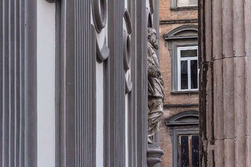 Statue of San Gaetano on San Paolo Maggiore’s façade, framed by a surviving Roman column from the Temple of the Dioscuri, Piazza San Gaetano, Naples.