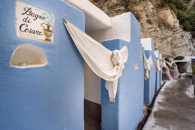 Powder-blue changing cabins/sign “Bagno di Cesare” at Cavascura.