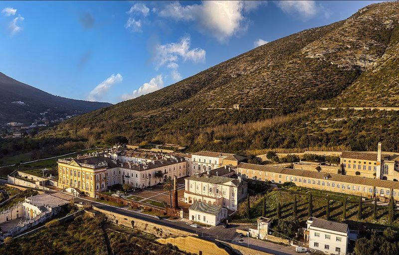 Aerial view of the San Leucio silk complex with workshops, courtyards, and hillside setting.
