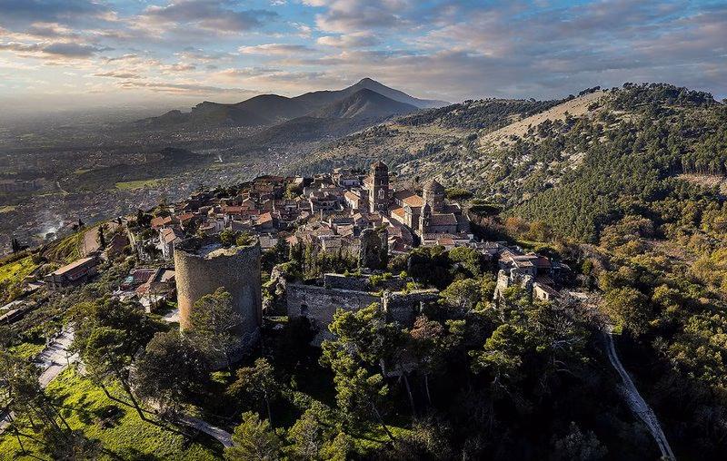 Aerial view of Casertavecchia hilltop village with cathedral and medieval castle ruins.