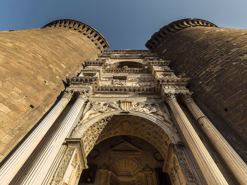 Renaissance triumphal arch of Maschio Angioino framed by the fortress’s twin towers, Naples—detail of the marble portal at Castel Nuovo.
