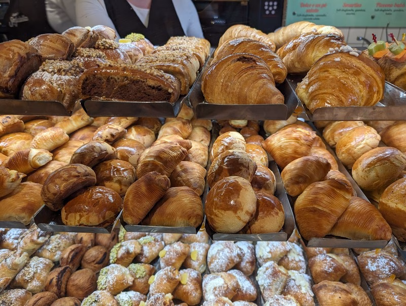 Sfogliatella Pastries in Naples Sfogliatella riccia and frolla pastries in a Neapolitan bakery display.