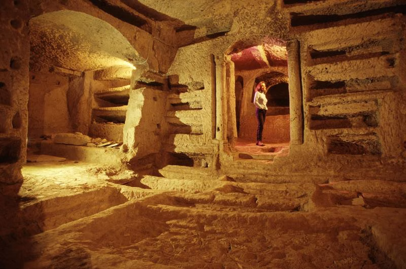 Visitor exploring the Catacombs of San Gennaro, Naples