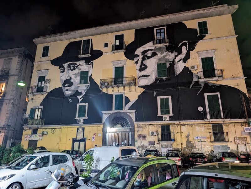 Totò mural on a building at night in Rione Sanità, Naples