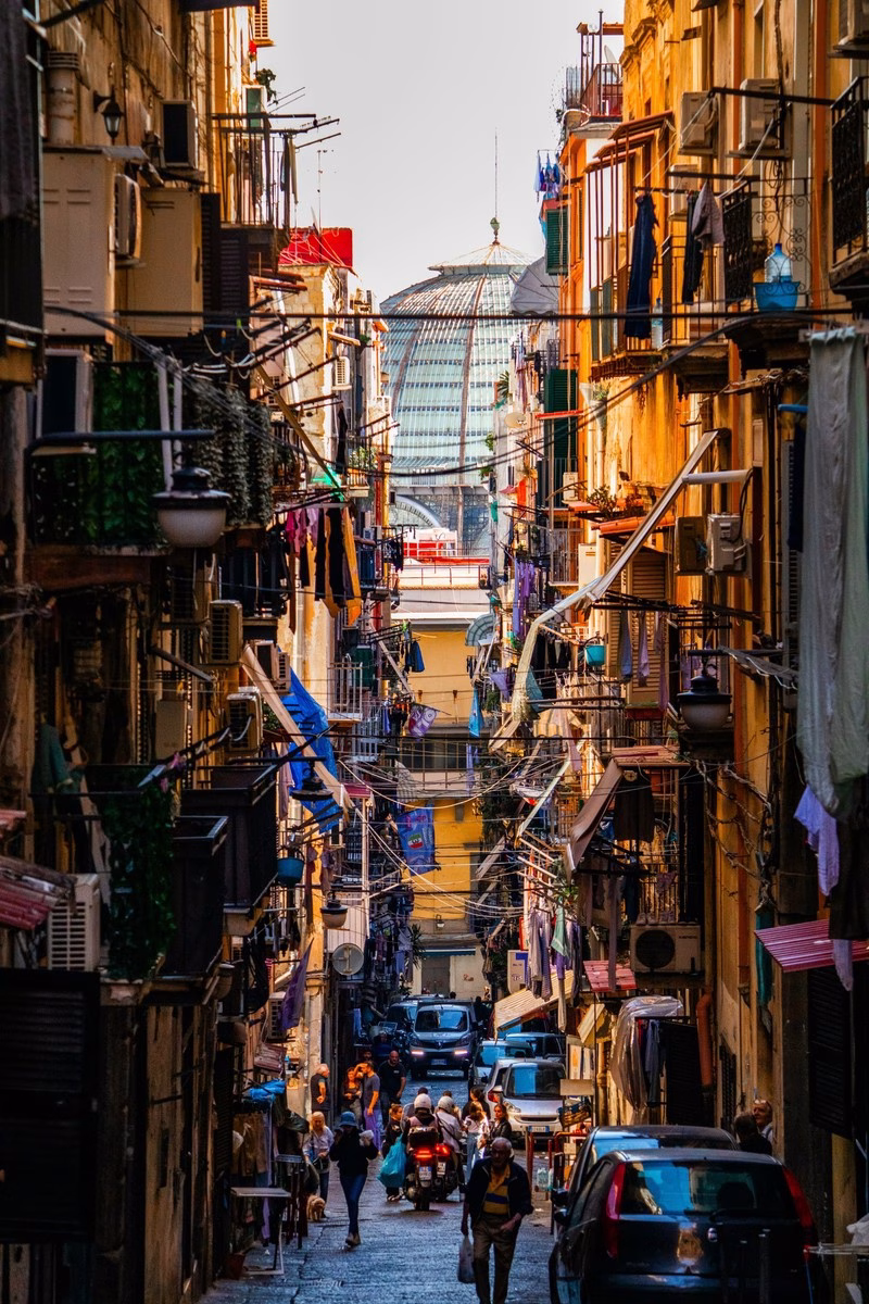 Spanish Quarters alley with balconies and washing lines aligned on the glass dome of Galleria Umberto I, Naples.