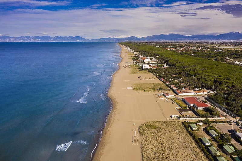 Aerial view of Paestum’s long sandy coastline with pine forest and the Gulf of Salerno in the distance