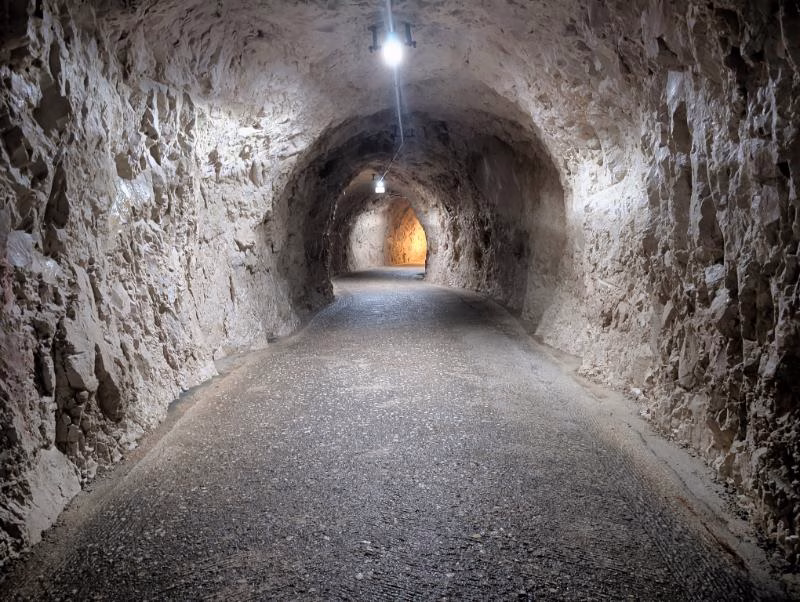 Frasassi Caves interior views showing the visitor walkway, carved tunnels, and calcite formations in Le Marche