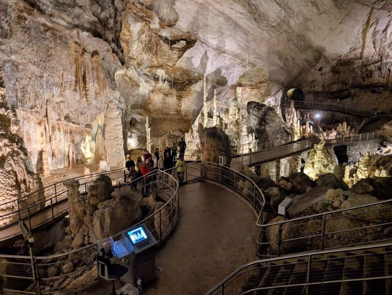 Frasassi Caves interior views showing the visitor walkway, carved tunnels, and calcite formations in Le Marche