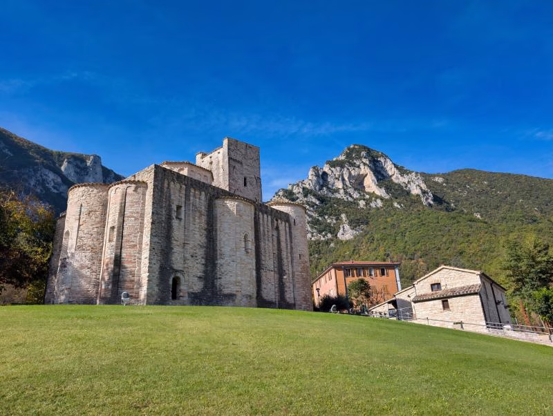 Romanesque Abbey of San Vittore delle Chiuse near Genga, set against the limestone mountains of the Frasassi valley