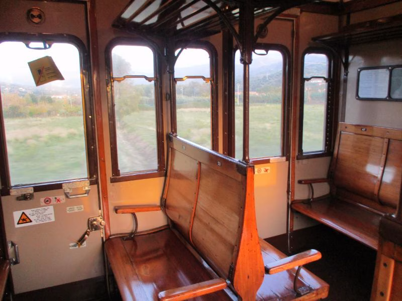 Interior of historic Italian train carriage with wooden seating