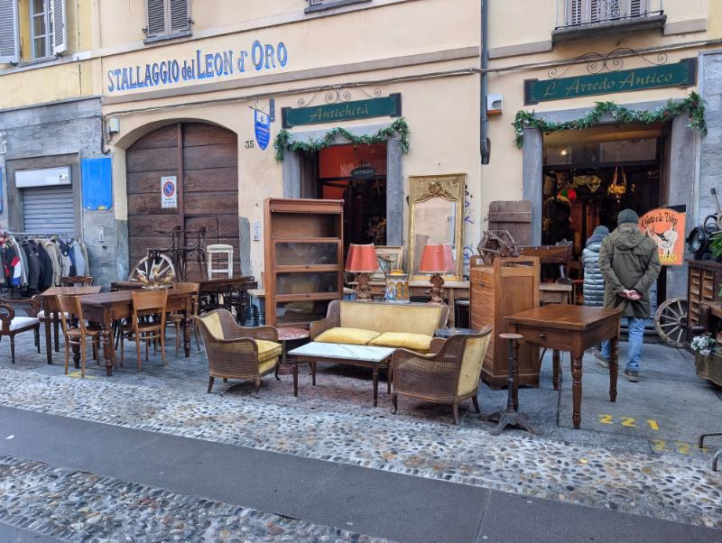 Antiques shop frontage near Porta Palazzo with vintage furniture arranged on the pavement