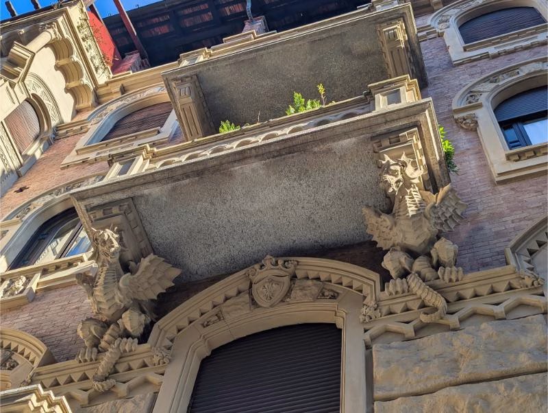 Dragon sculptures at Casa della Vittoria entrance, Turin Dragon sculptures framing the entrance of Casa della Vittoria in Turin, Liberty architecture detail