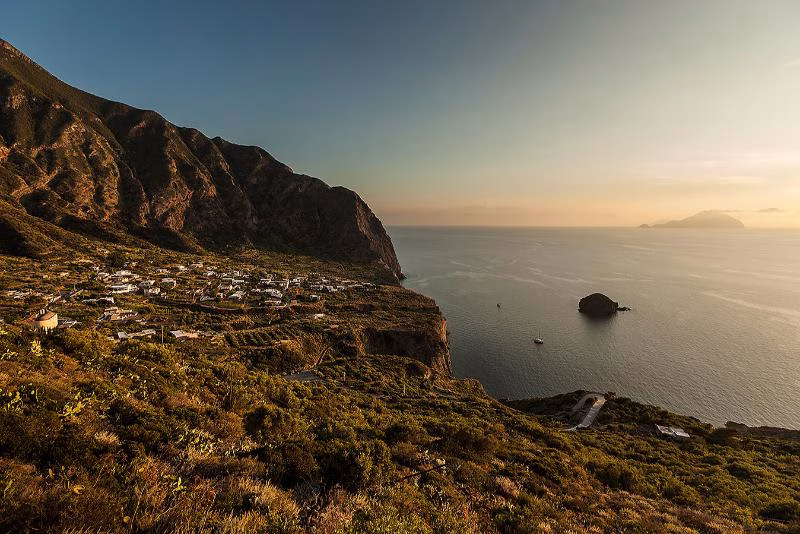 Elemental island tempo Terraced village on a hillside overlooking the sea at sunset in the Aeolian Islands