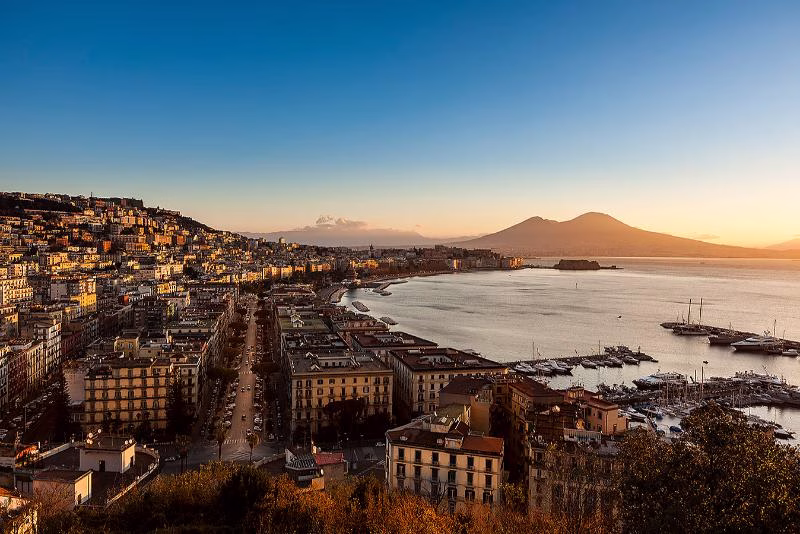 Purposeful urban rhythm Panoramic view of Naples and Vesuvius at sunset