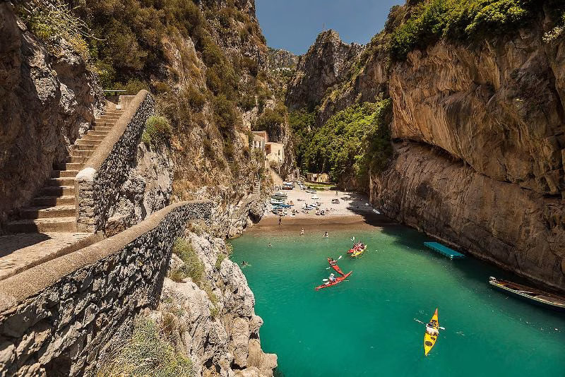 Fiordo di Furore — hidden inlet between Positano and Praiano Fiordo di Furore on the Amalfi Coast with turquoise water and kayaks below dramatic cliffs