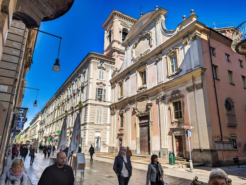Chiesa di San Dalmazzo on Via Garibaldi in Turin, at the corner with Via delle Orfane, with a baroque façade along the historic street.