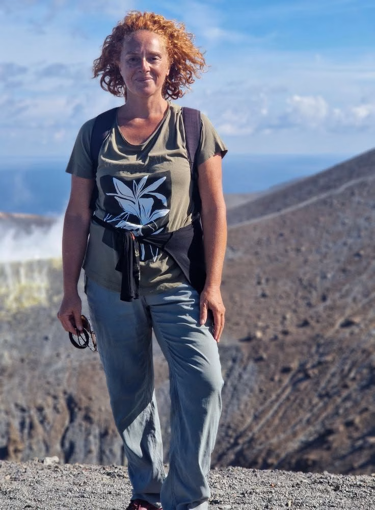 Giusi standing on Mount Etna’s volcanic terrain