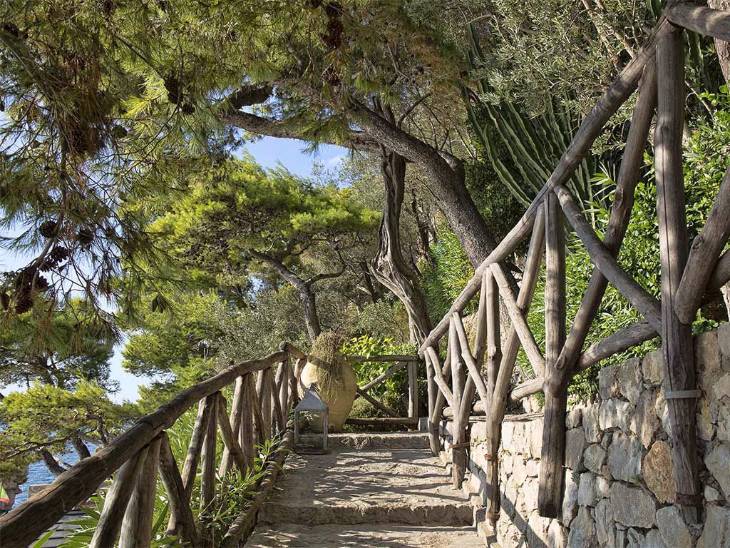The landscaped path through Hotel Capo La Gala's terraced coastal grounds