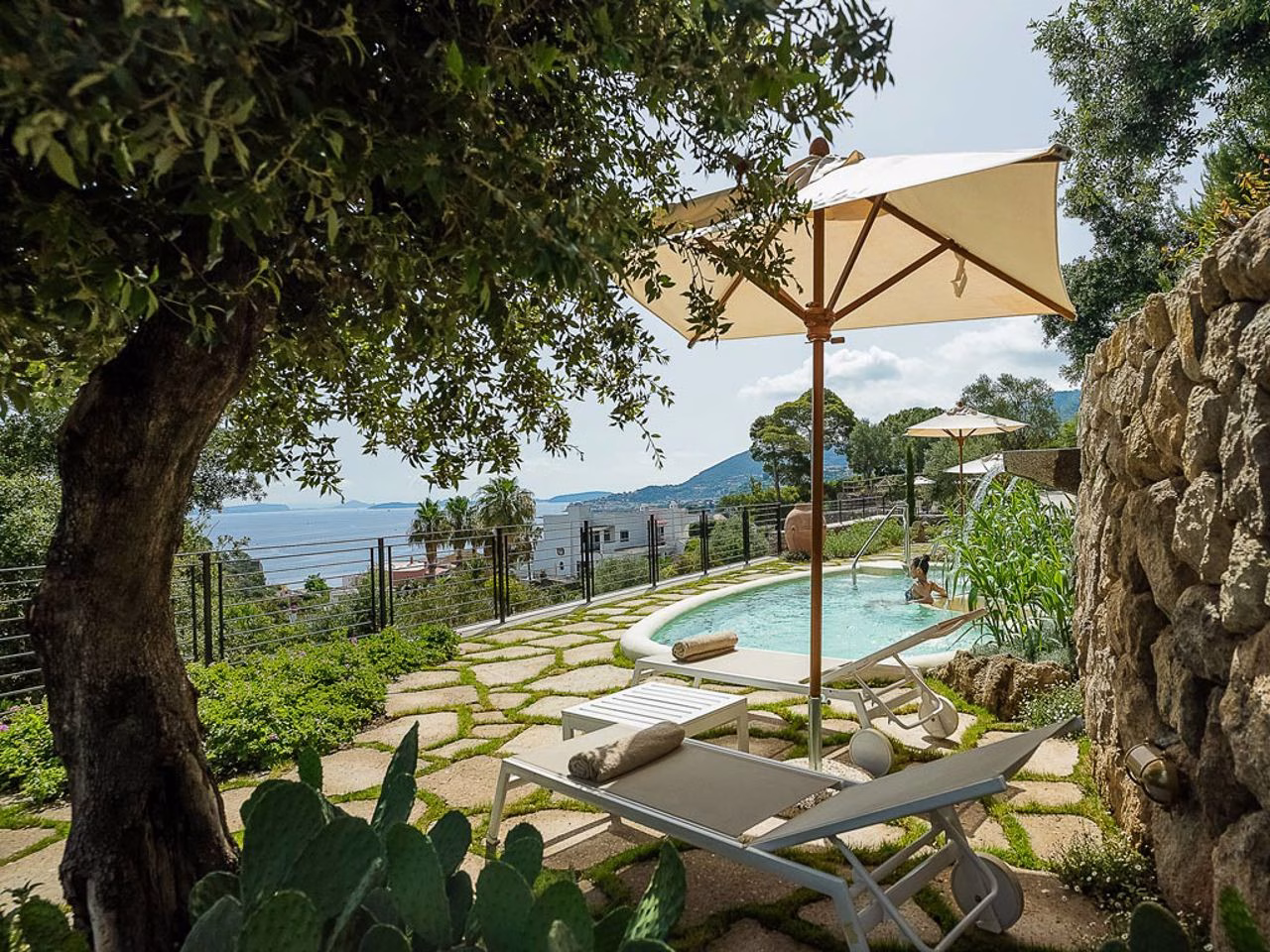 Swimming pool surrounded by Mediterranean gardens at Botania Relais and Spa