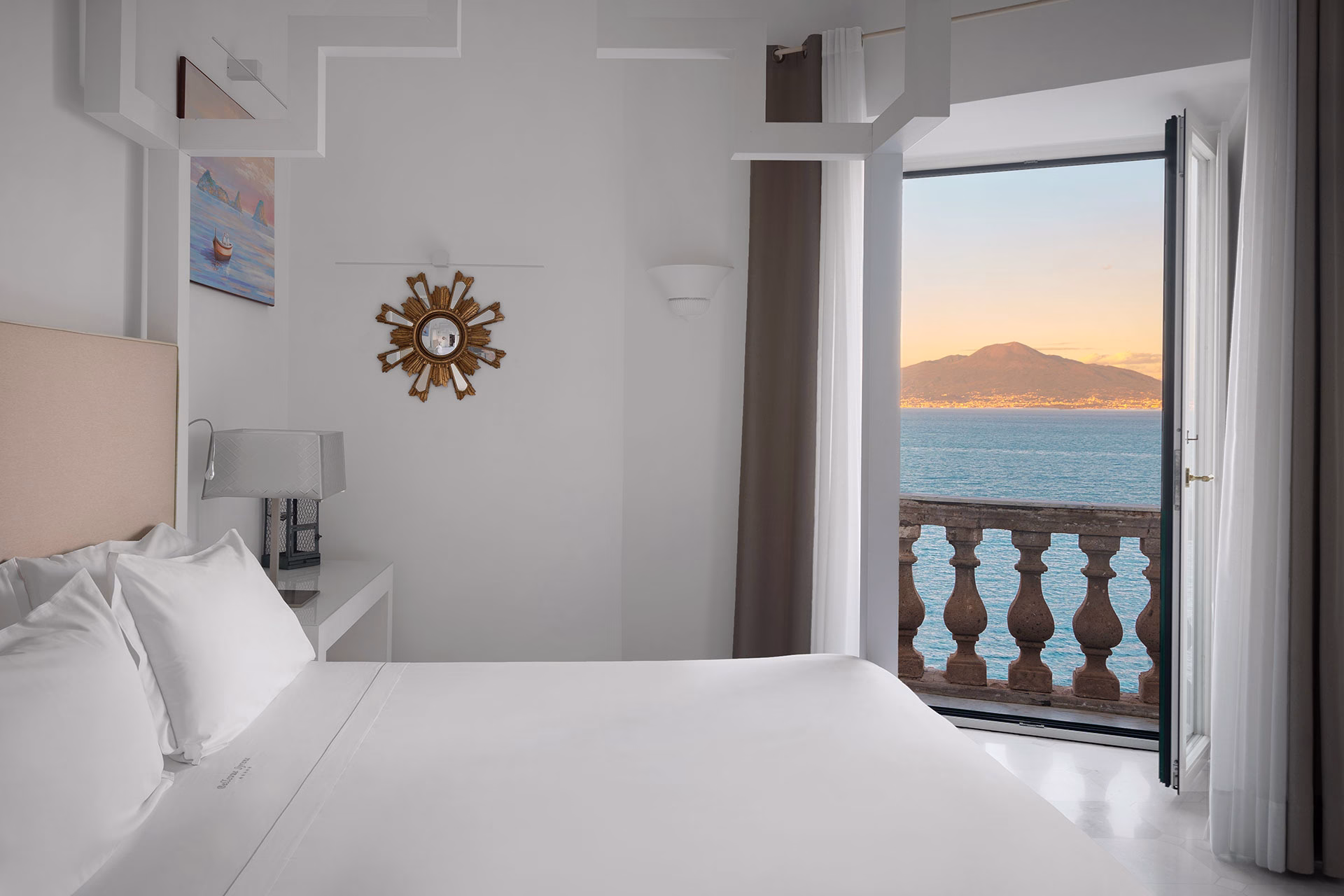 Bedroom and sea-facing balcony in the Camelia Suite at Bellevue Syrene