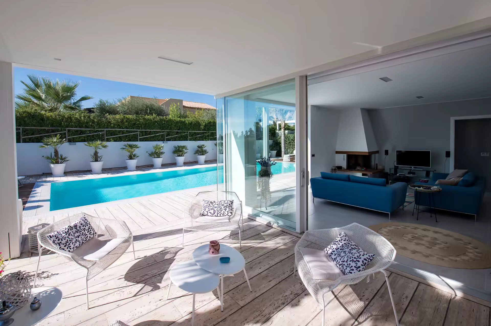Covered outdoor living area beside the pool at Villa Spuma