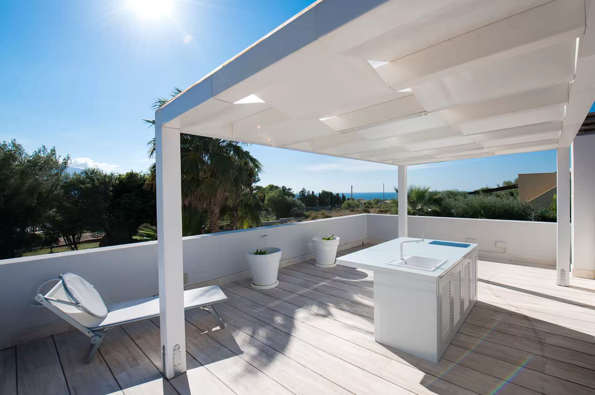 Upper sun terrace with partial sea view at Villa Spuma