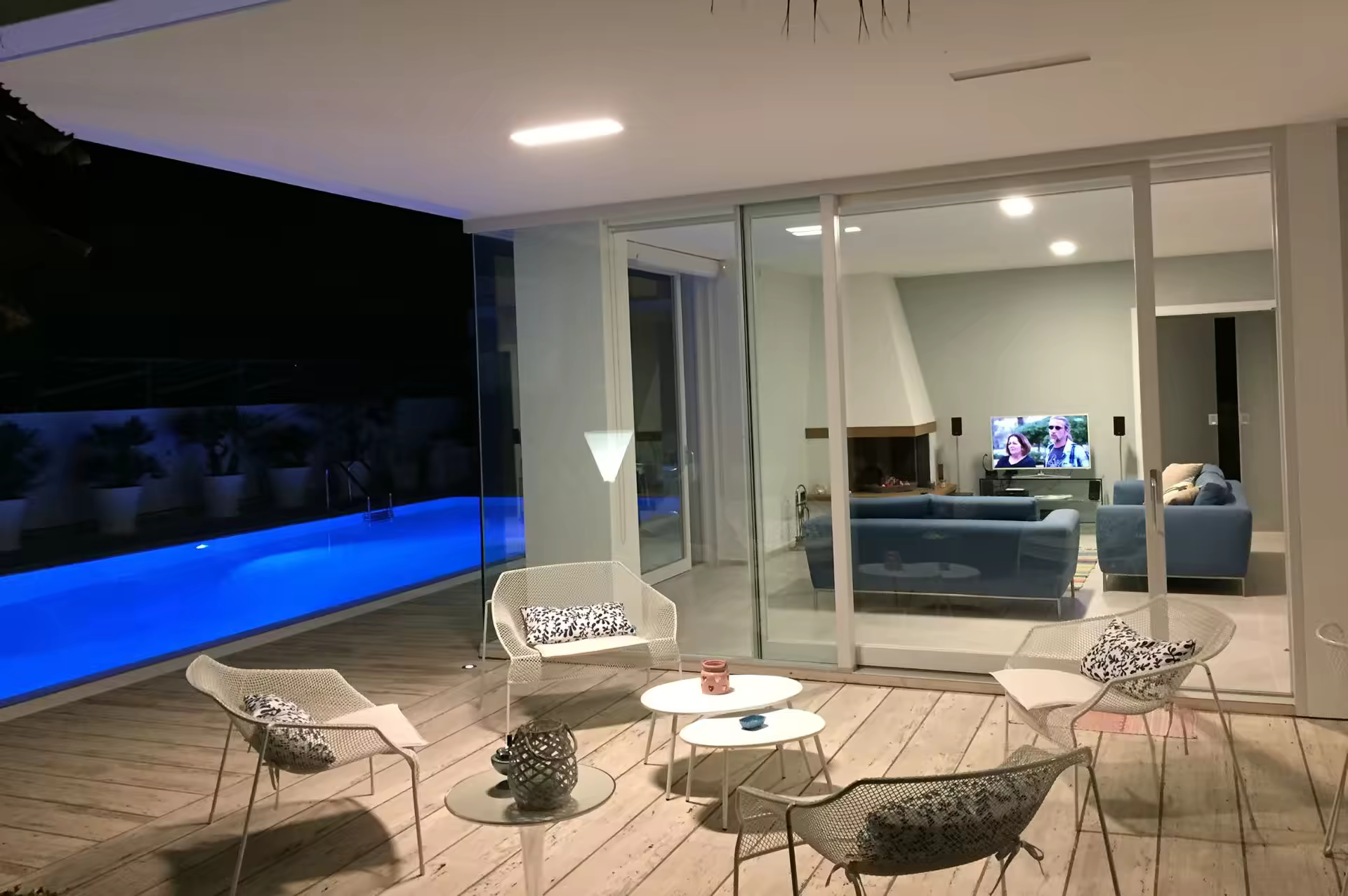 Pool and outdoor living area illuminated at night at Villa Spuma