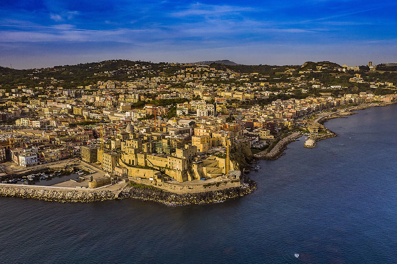 Aerial view of Rione Terra, Pozzuoli town and the bay