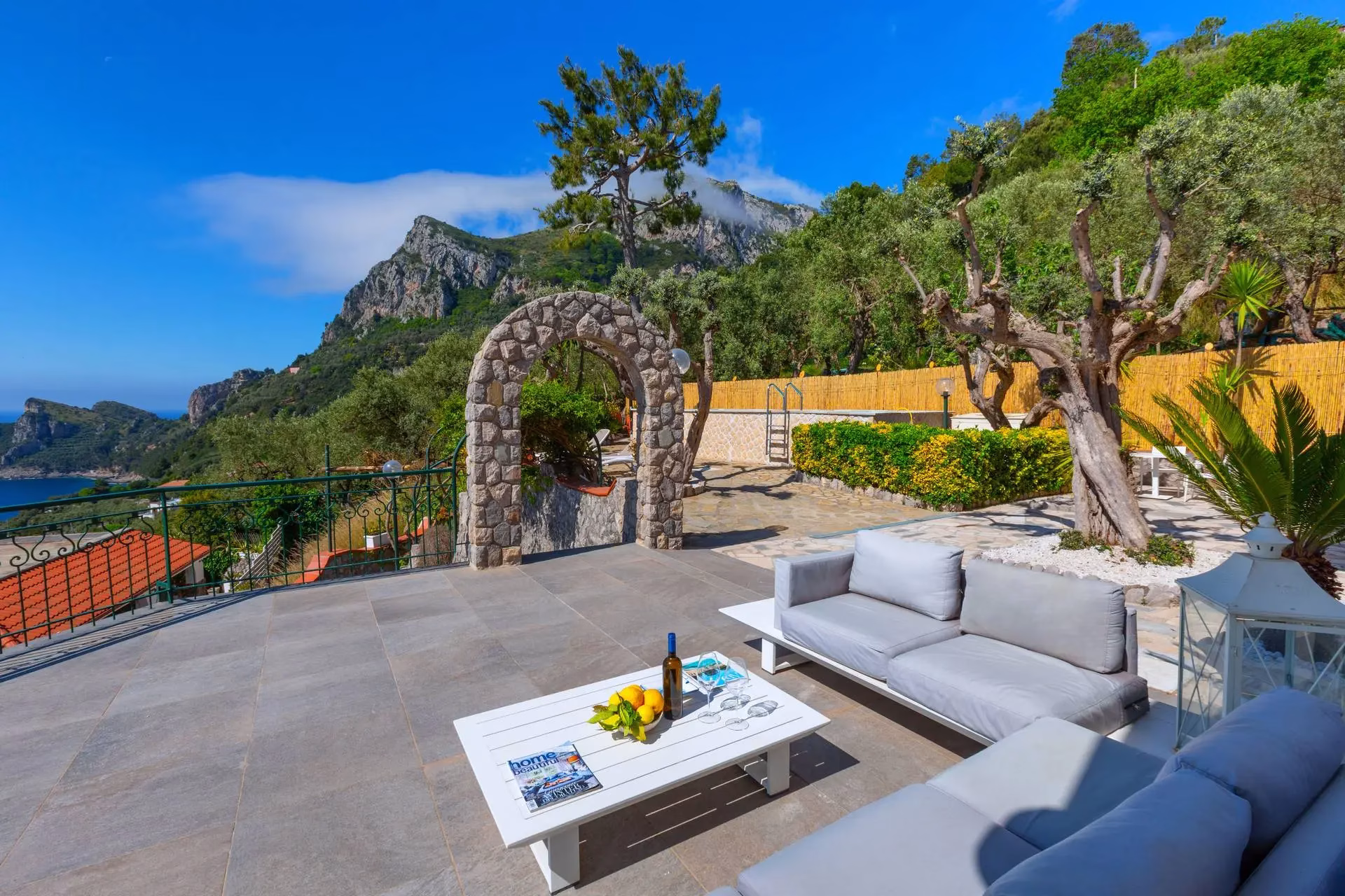 Outdoor lounge beside Villa Mira's pool