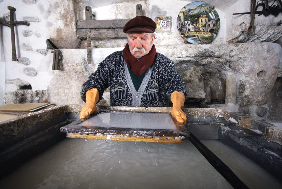 Papermaker lifting a mould from a vat in Amalfi