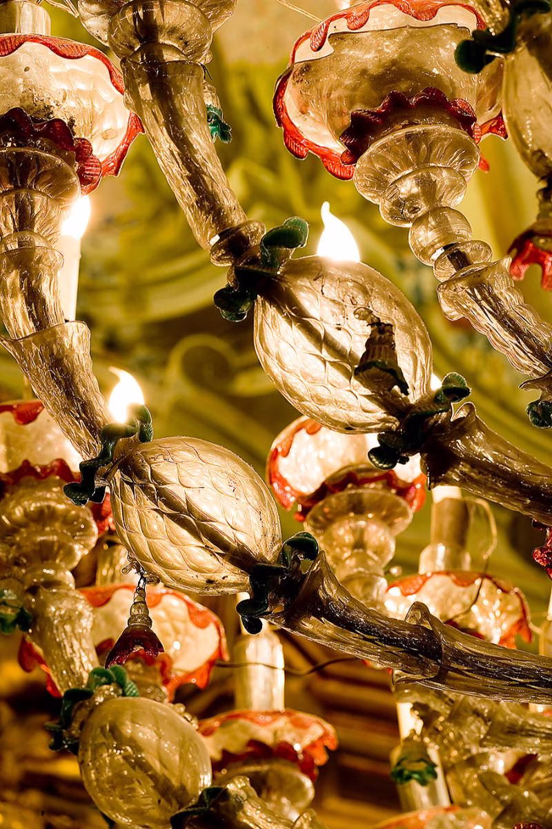 Close-up of coloured glass flowers and leaves on a chandelier