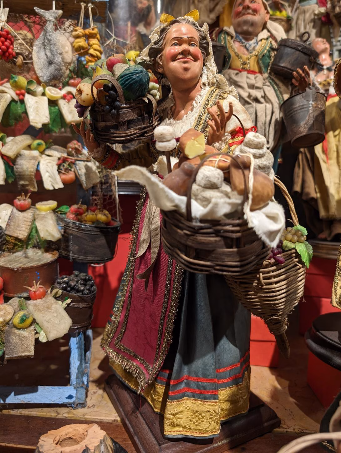 Market-seller figurine with baskets of food at San Gregorio Armeno