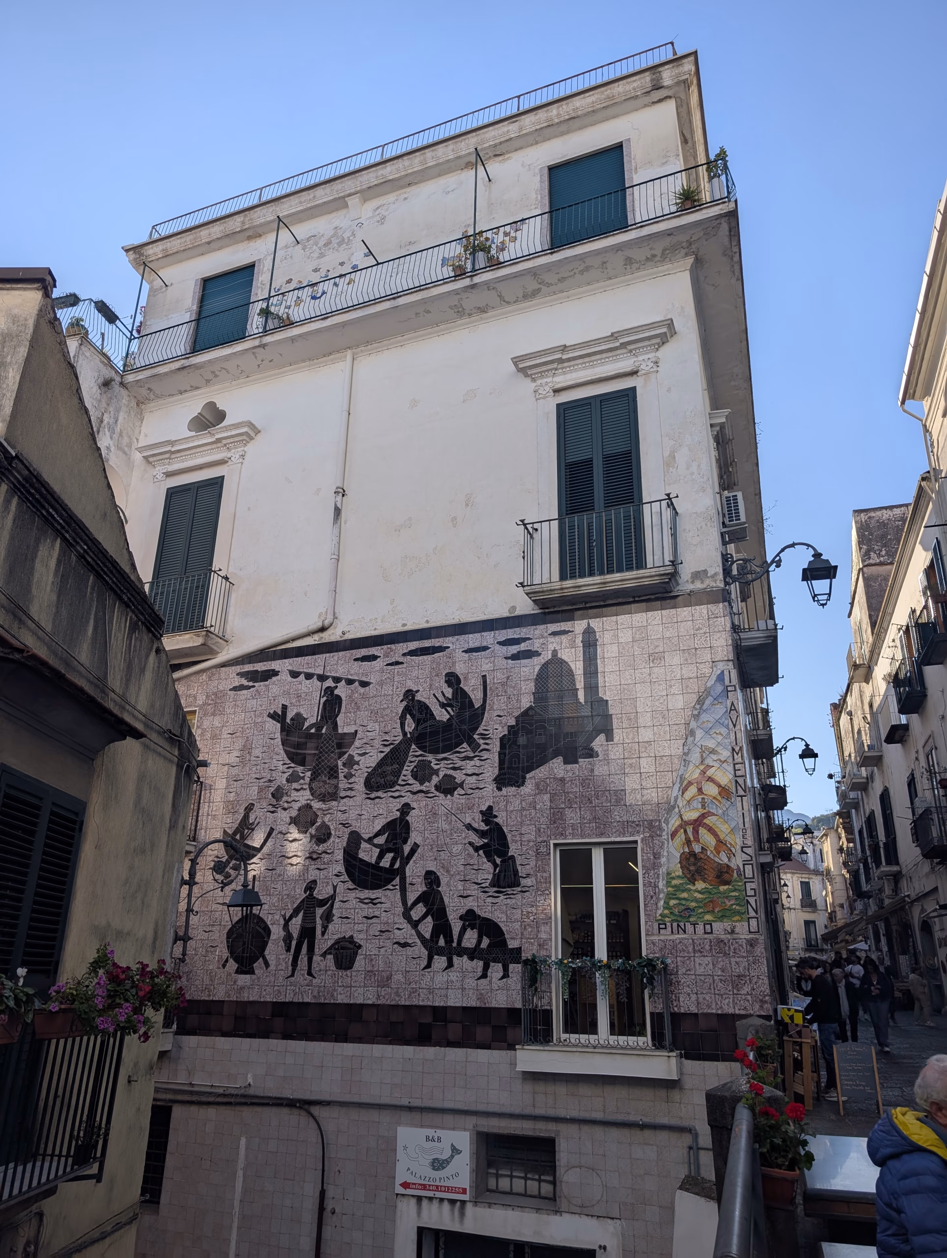 A Vietri building covered with ceramic panels depicting fishing and local life