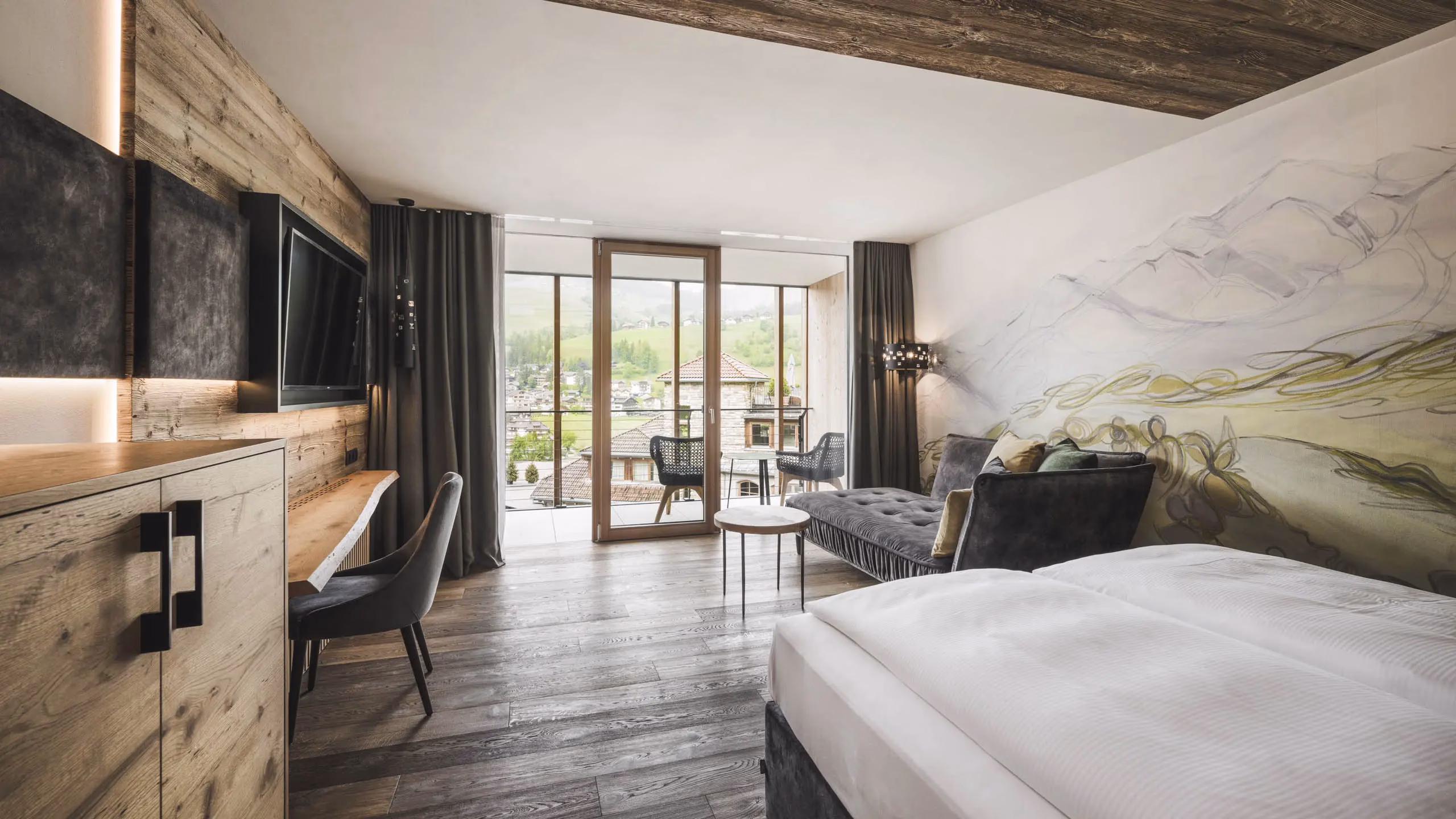 Dolomites Lodge room with a bed sofa and balcony
