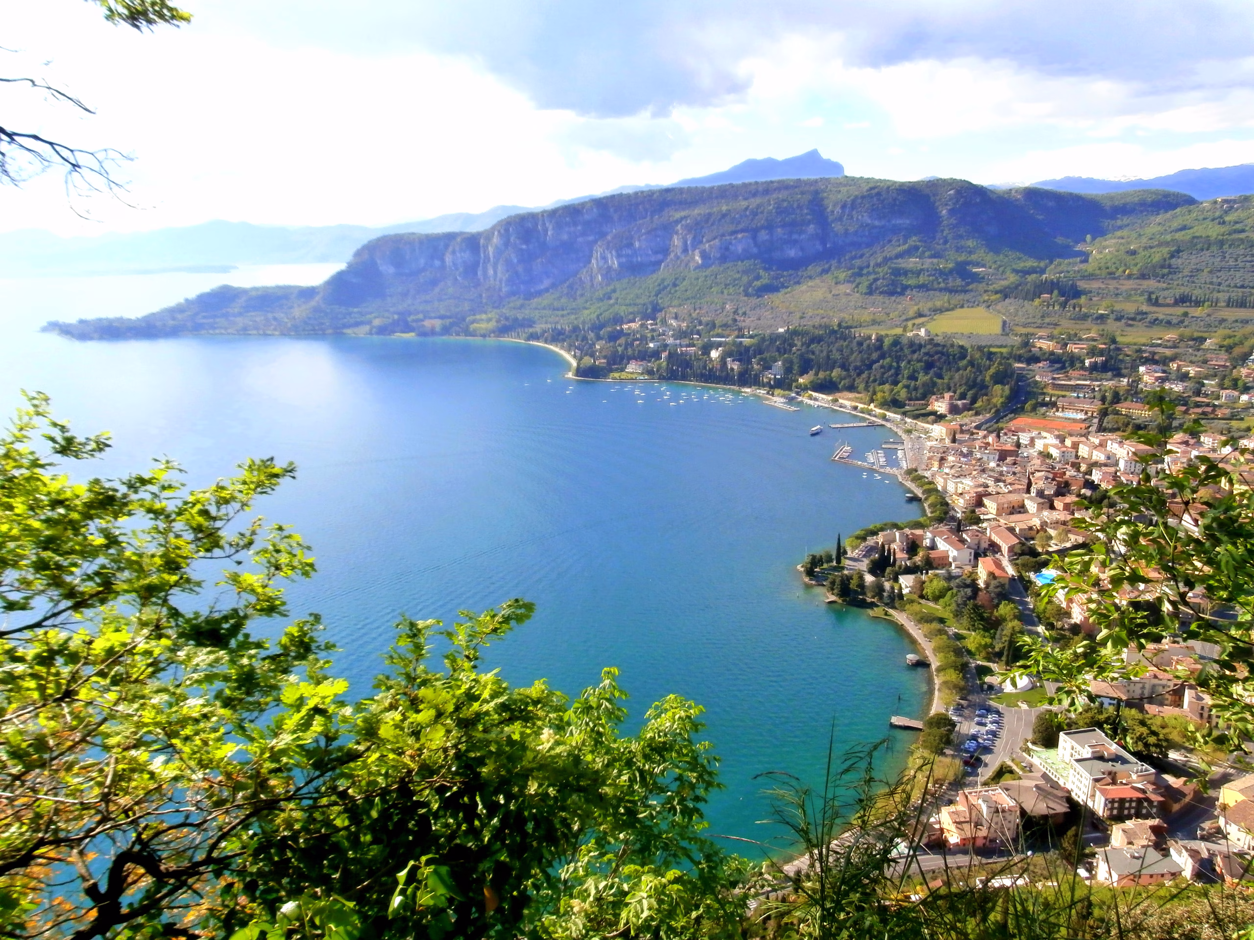 Garda town and its curved bay seen from the Rocca, with wooded hills beyond