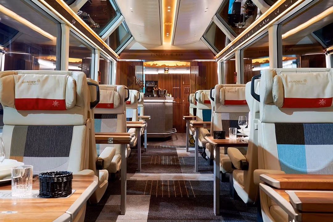 Excellence Class carriage with individual window seats and tables for two