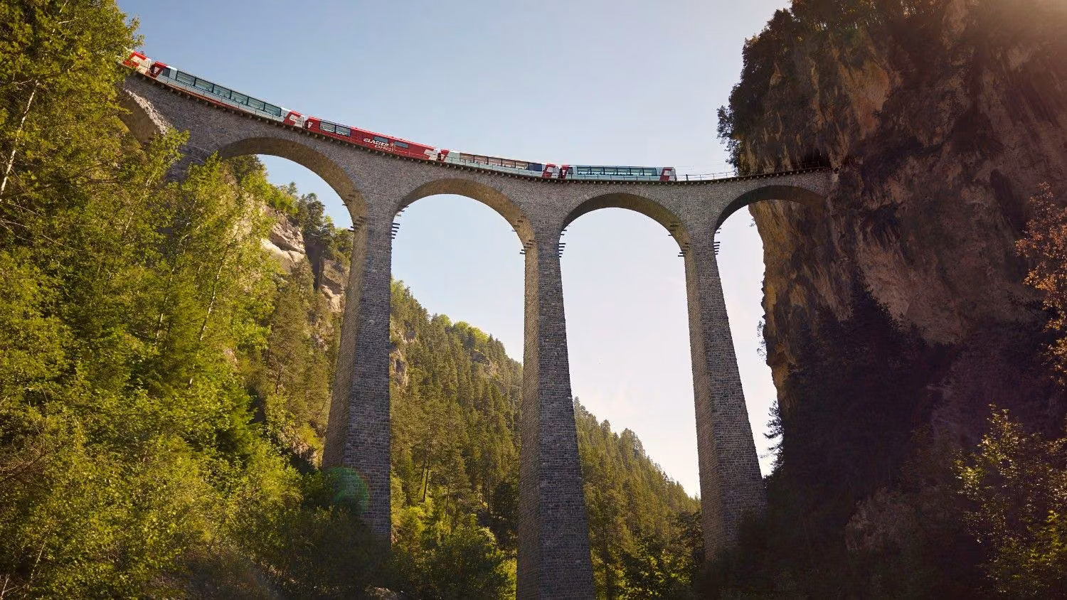 Glacier Express crossing the Landwasser Viaduct into a rock tunnel