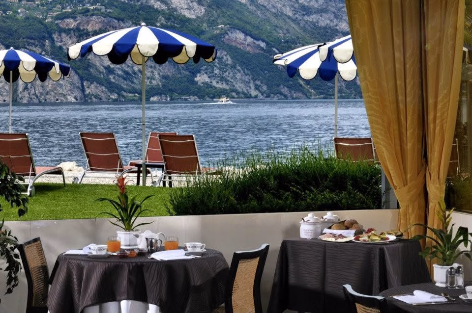 Breakfast tables overlooking Lake Garda at Hotel Castello