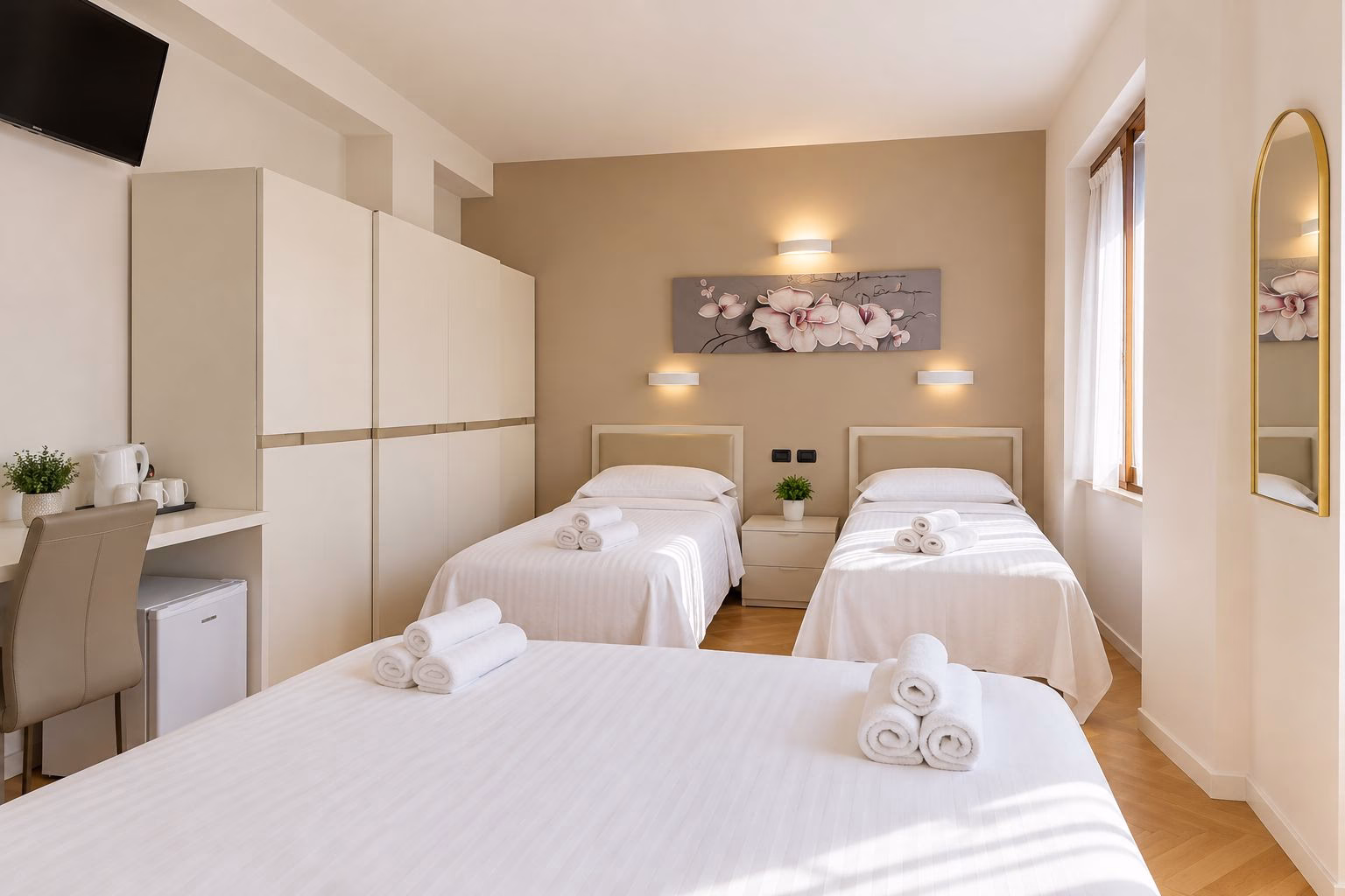 Room 12 with a double bed and two single beds in one bedroom
