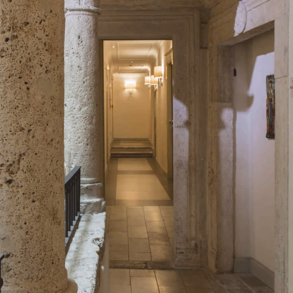 The palazzo’s stone columns and corridor