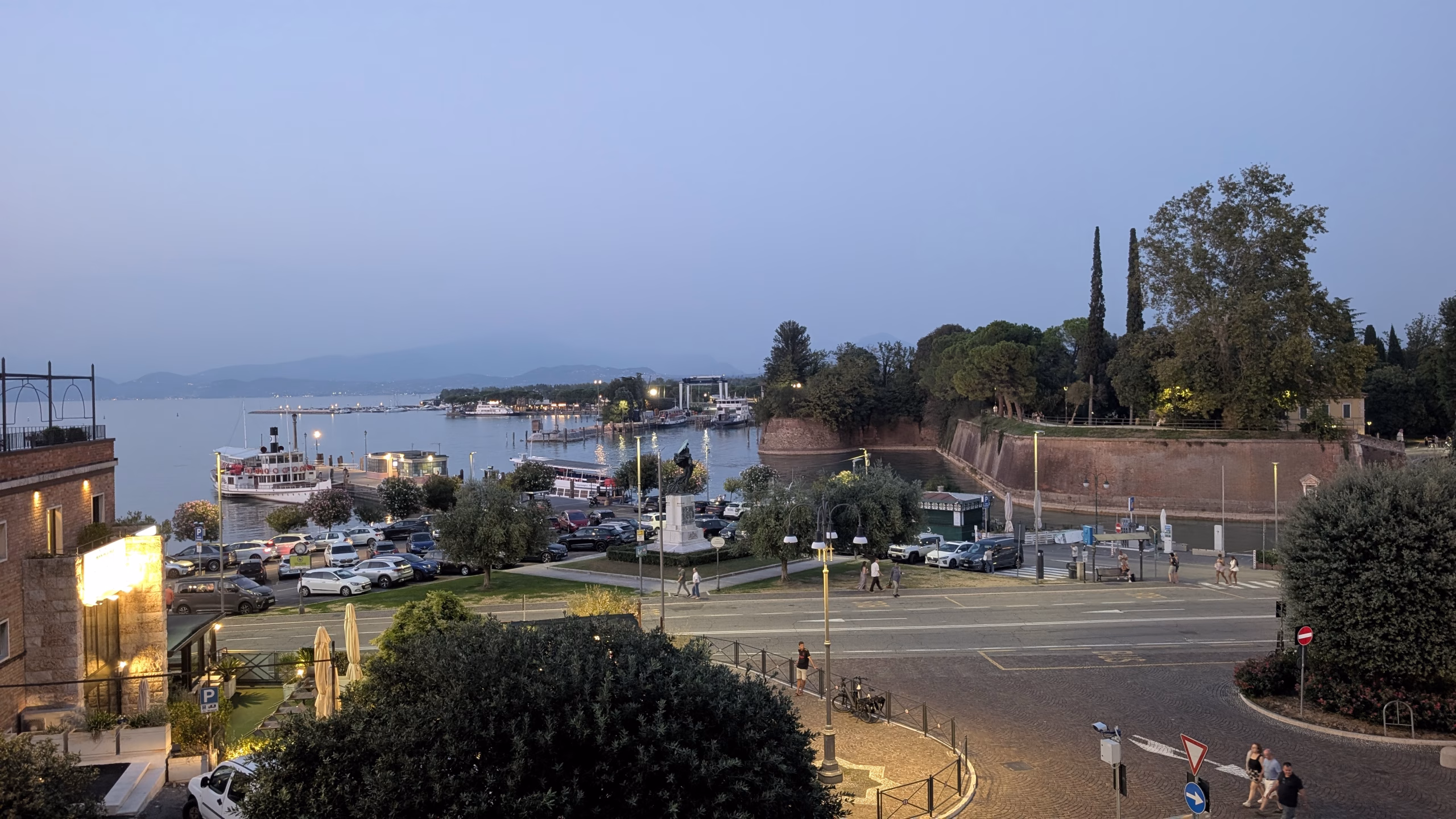 Lake Garda, boats and Peschiera’s brick bastions seen from above at dusk