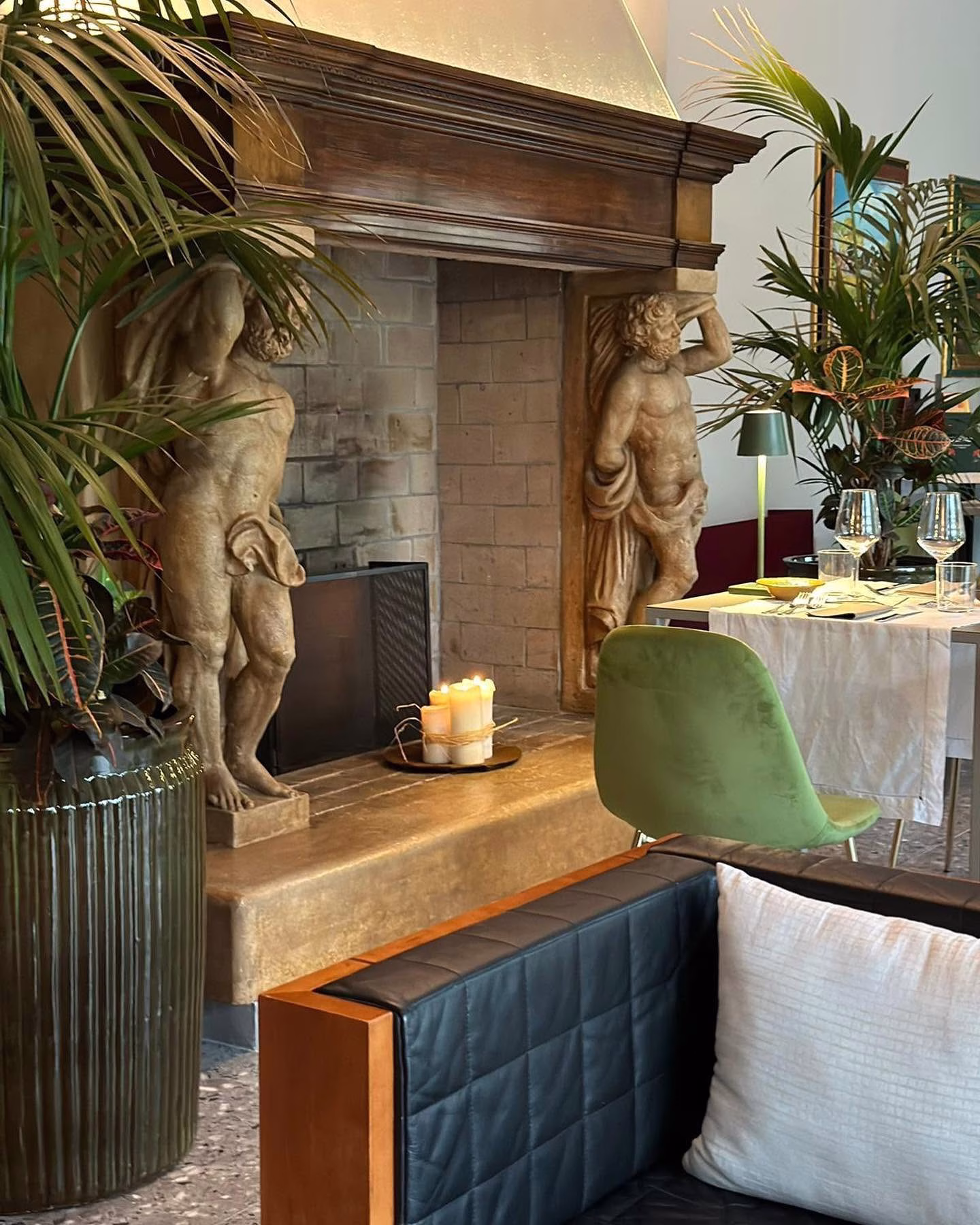 Breakfast table and carved fireplace in the dining room at Relais Villa Borghetto