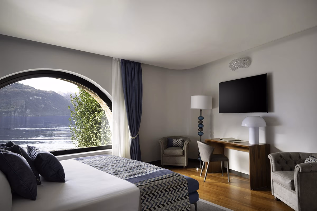 Tivano Suite bedroom with arched lake-facing window