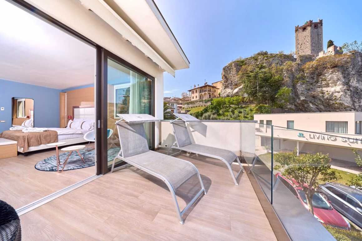 Lake-facing terrace of Suite Castello with loungers and castle views